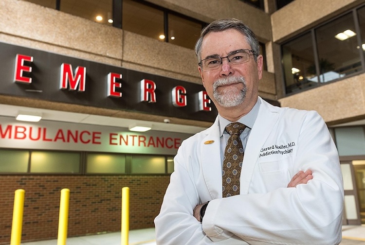 Man stands in front of emergency department