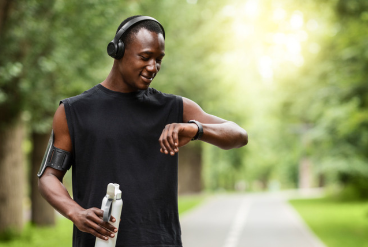 A runner looks at his smartwatch